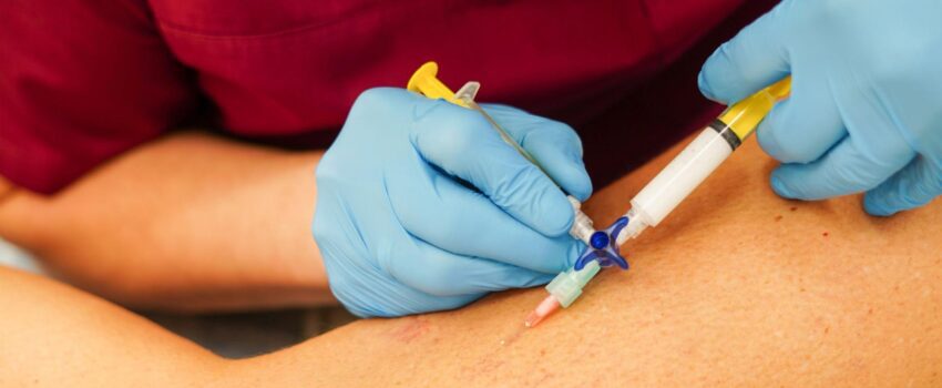 Leg with doctor providing sclerotherapy injection